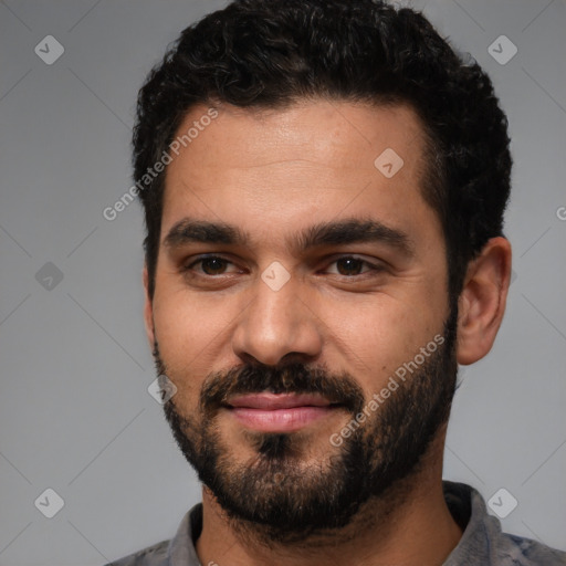 Joyful white young-adult male with short  black hair and brown eyes