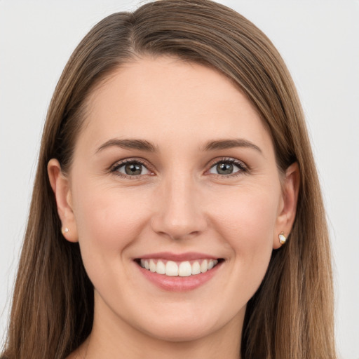 Joyful white young-adult female with long  brown hair and grey eyes