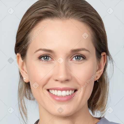 Joyful white young-adult female with medium  brown hair and grey eyes