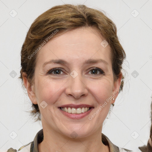 Joyful white adult female with medium  brown hair and grey eyes