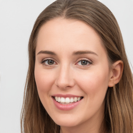 Joyful white young-adult female with long  brown hair and grey eyes