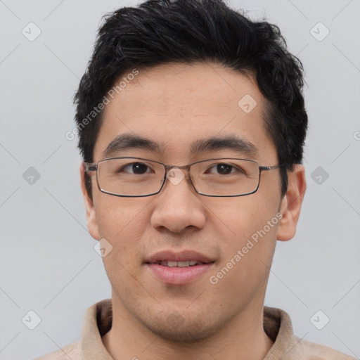 Joyful asian young-adult male with short  black hair and brown eyes