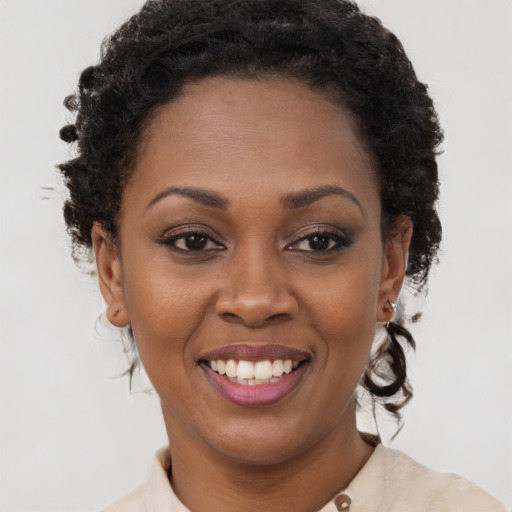 Joyful black young-adult female with short  brown hair and brown eyes
