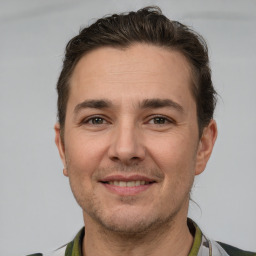 Joyful white adult male with short  brown hair and brown eyes