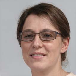 Joyful white adult female with medium  brown hair and blue eyes