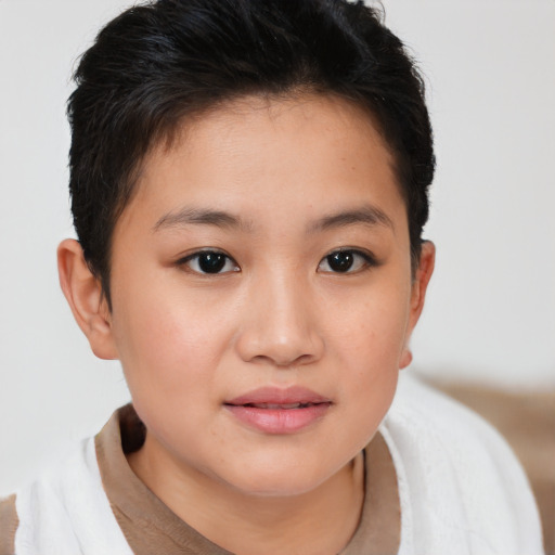 Joyful asian child female with short  brown hair and brown eyes