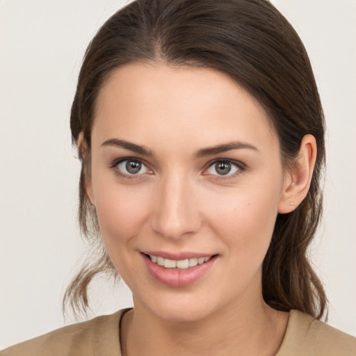 Joyful white young-adult female with medium  brown hair and brown eyes