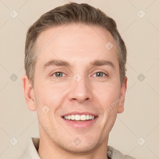 Joyful white adult male with short  brown hair and grey eyes