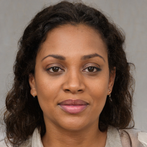 Joyful black young-adult female with medium  brown hair and brown eyes
