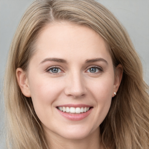 Joyful white young-adult female with long  brown hair and grey eyes