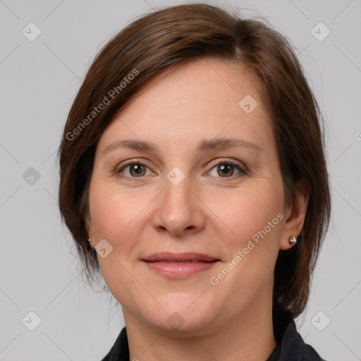 Joyful white adult female with medium  brown hair and grey eyes