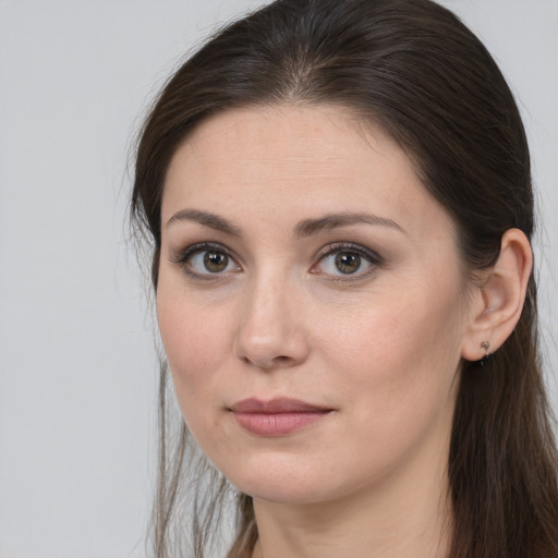 Joyful white young-adult female with long  brown hair and brown eyes