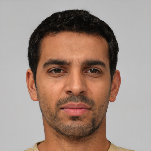 Neutral latino young-adult male with short  black hair and brown eyes