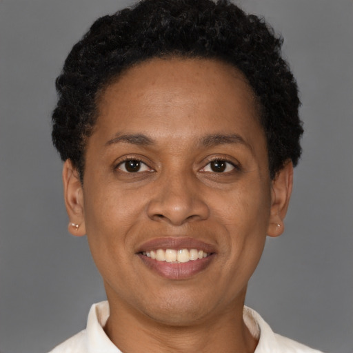 Joyful black adult female with short  brown hair and brown eyes