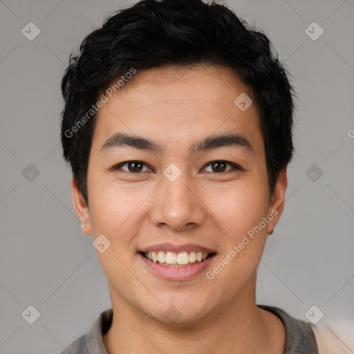 Joyful asian young-adult male with short  black hair and brown eyes