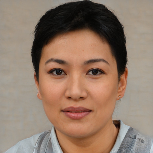 Joyful asian young-adult female with short  black hair and brown eyes