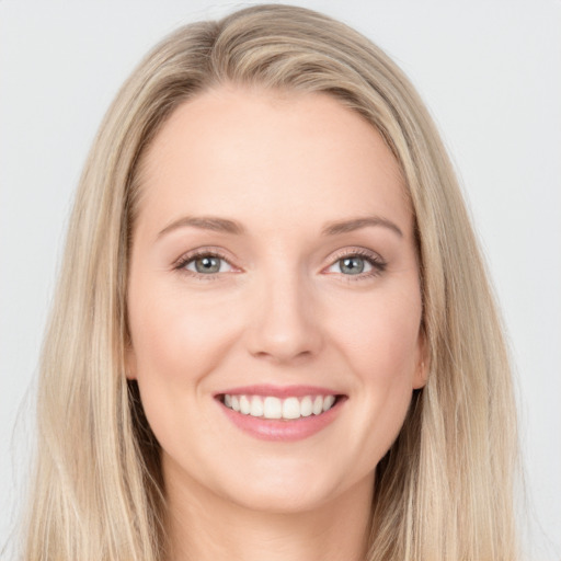 Joyful white young-adult female with long  brown hair and blue eyes