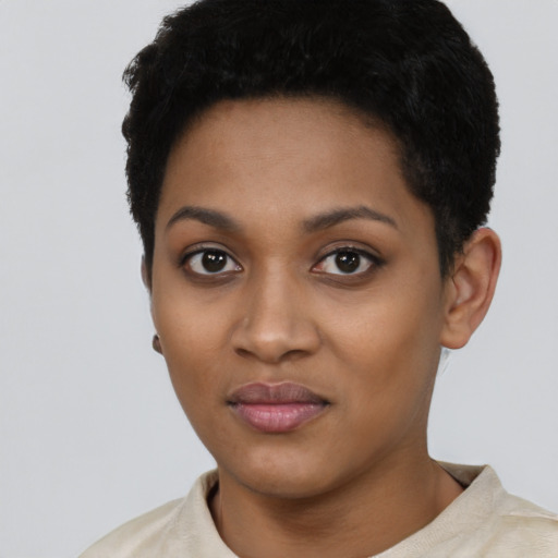 Joyful black young-adult female with short  black hair and brown eyes