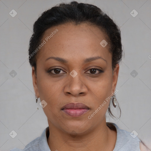 Joyful black adult female with short  brown hair and brown eyes