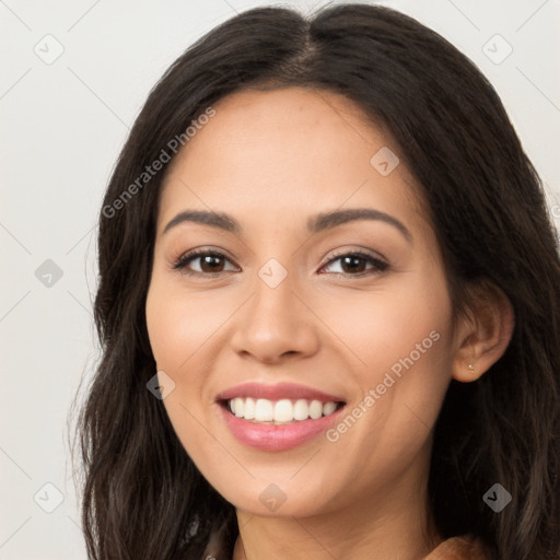 Joyful latino young-adult female with long  brown hair and brown eyes