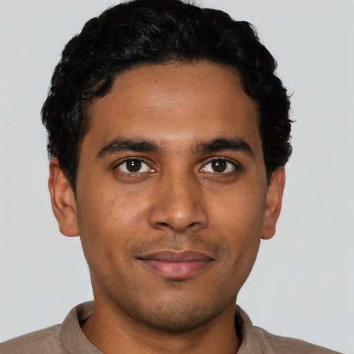 Joyful latino young-adult male with short  black hair and brown eyes