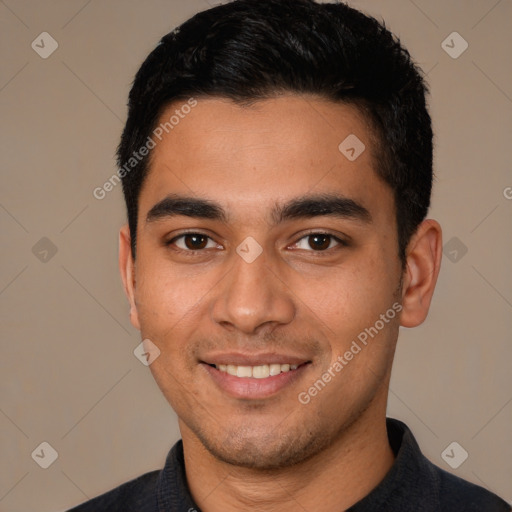 Joyful latino young-adult male with short  black hair and brown eyes