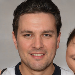 Joyful white adult male with short  brown hair and brown eyes