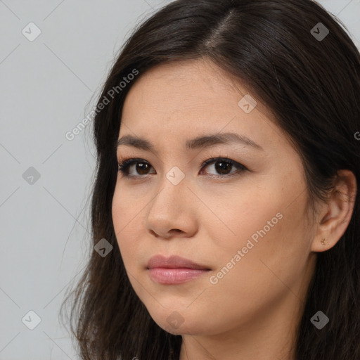 Joyful asian young-adult female with long  brown hair and brown eyes