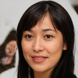 Joyful asian young-adult female with long  brown hair and brown eyes