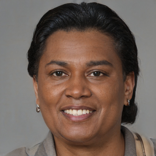 Joyful latino adult female with short  brown hair and brown eyes