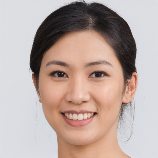 Joyful asian young-adult female with medium  brown hair and brown eyes