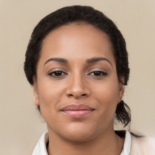 Joyful latino young-adult female with short  brown hair and brown eyes