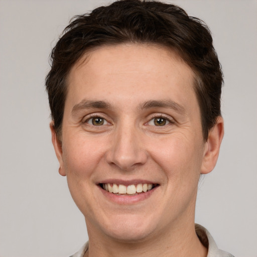 Joyful white adult male with short  brown hair and grey eyes