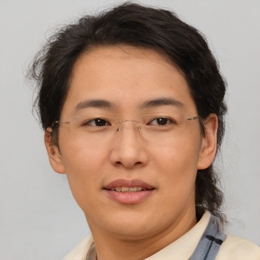 Joyful asian adult female with short  brown hair and brown eyes