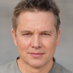 Joyful white adult male with short  brown hair and grey eyes