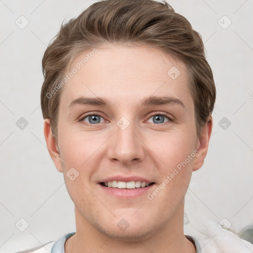 Joyful white young-adult male with short  brown hair and grey eyes