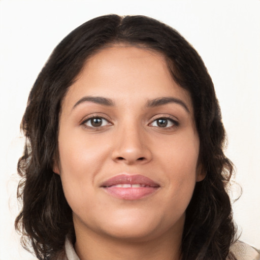 Joyful white young-adult female with long  brown hair and brown eyes