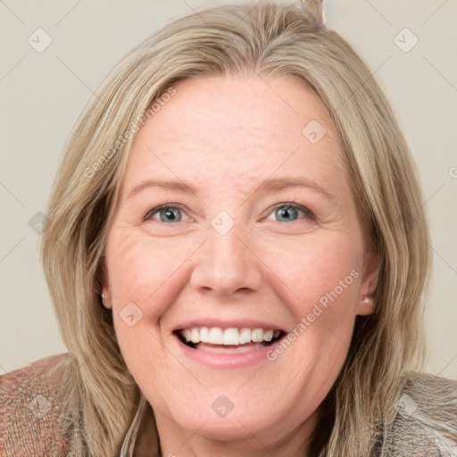 Joyful white adult female with medium  brown hair and blue eyes