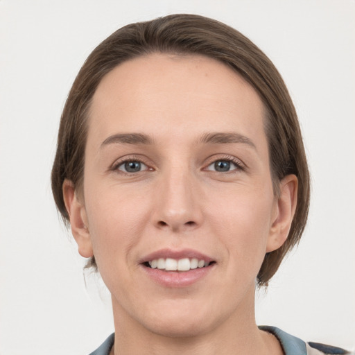 Joyful white young-adult female with medium  brown hair and grey eyes