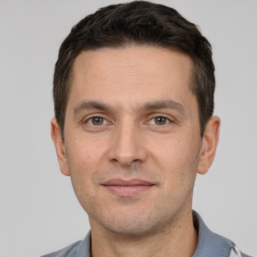 Joyful white adult male with short  brown hair and brown eyes