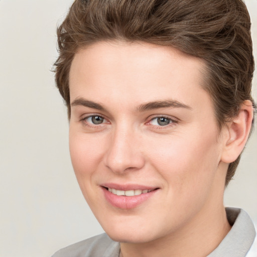 Joyful white young-adult female with short  brown hair and grey eyes