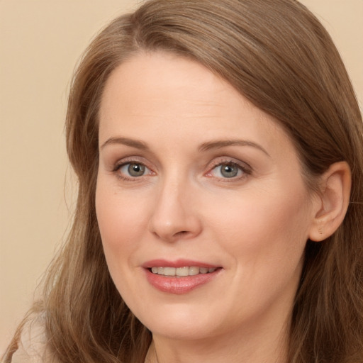 Joyful white adult female with long  brown hair and brown eyes