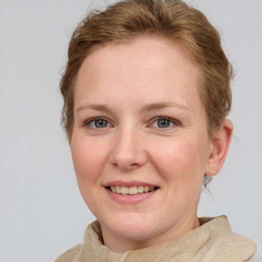 Joyful white adult female with medium  brown hair and blue eyes