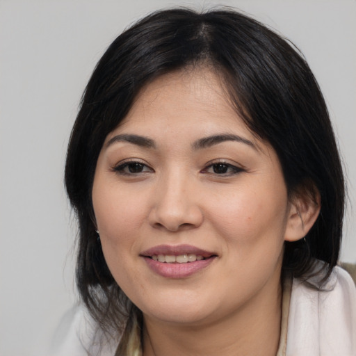 Joyful asian young-adult female with medium  brown hair and brown eyes