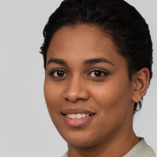 Joyful latino young-adult female with short  black hair and brown eyes