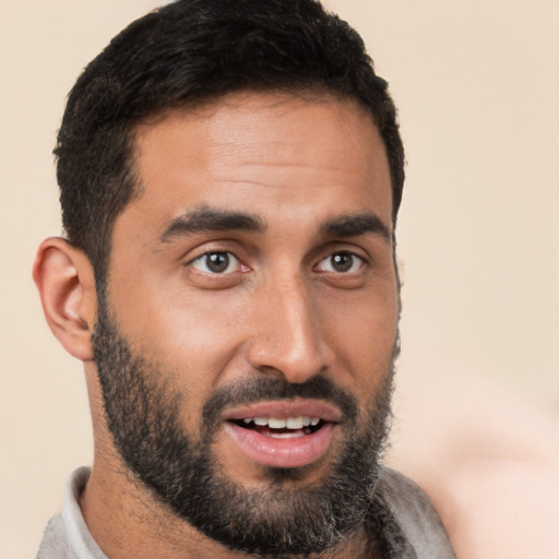 Joyful white young-adult male with short  black hair and brown eyes