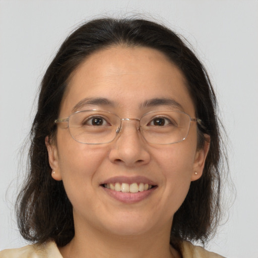 Joyful white adult female with medium  brown hair and brown eyes