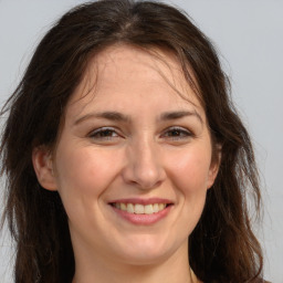 Joyful white adult female with long  brown hair and brown eyes