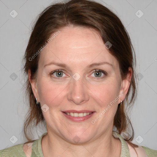 Joyful white adult female with medium  brown hair and blue eyes