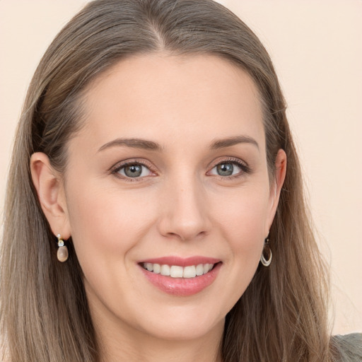 Joyful white young-adult female with long  brown hair and blue eyes